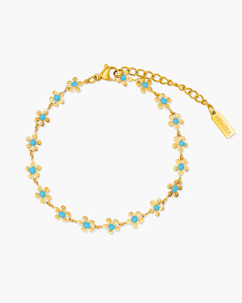 Gold bracelet with turquoise stones on a white background